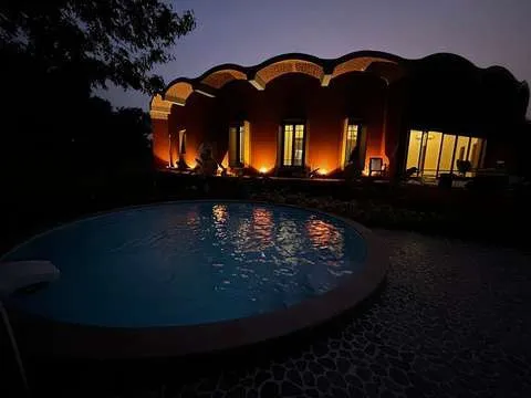 Isha Vasya farmhouse at dusk